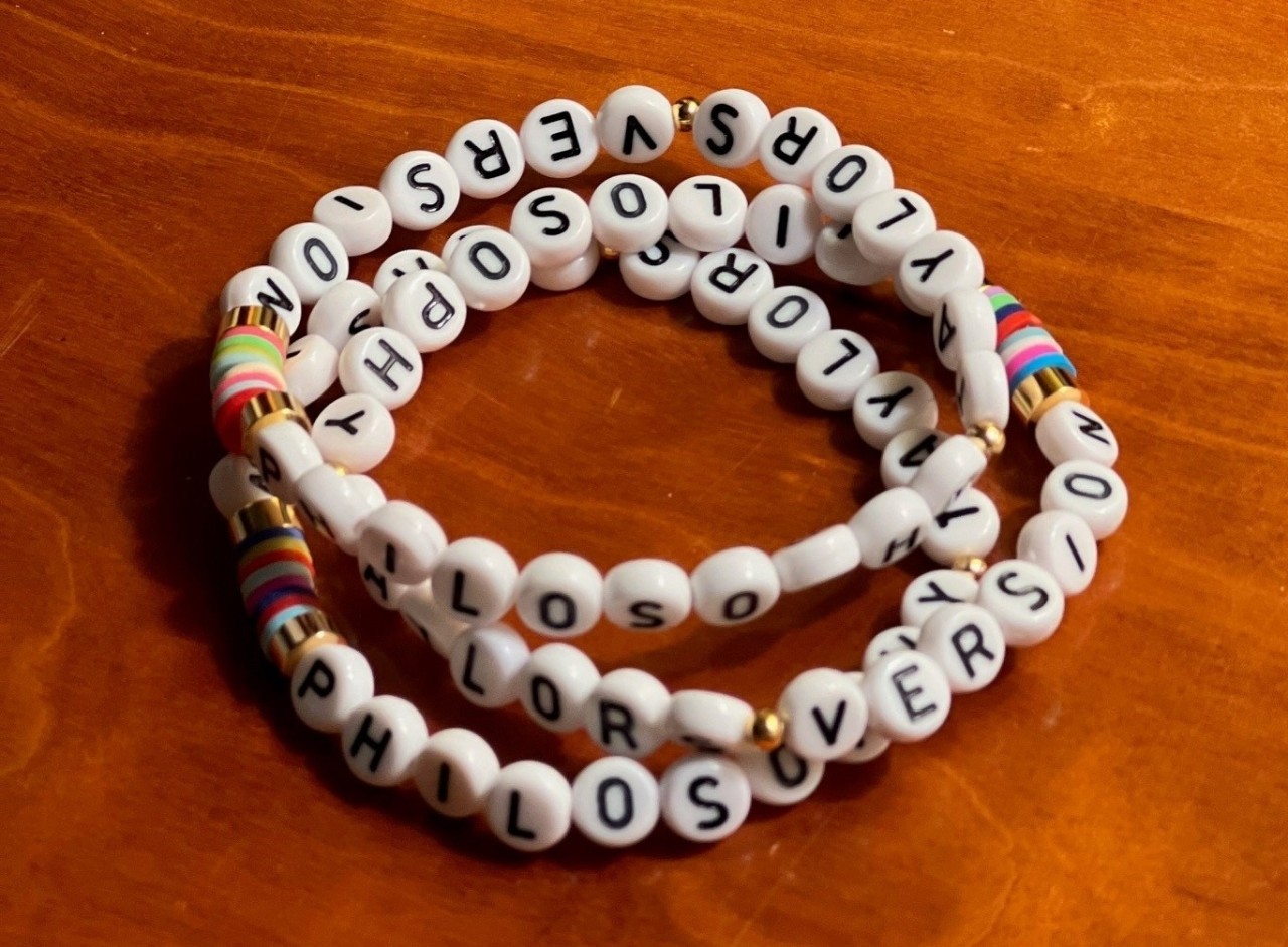 Stack of friendship bracelets that spell out "Taylor's Version"
