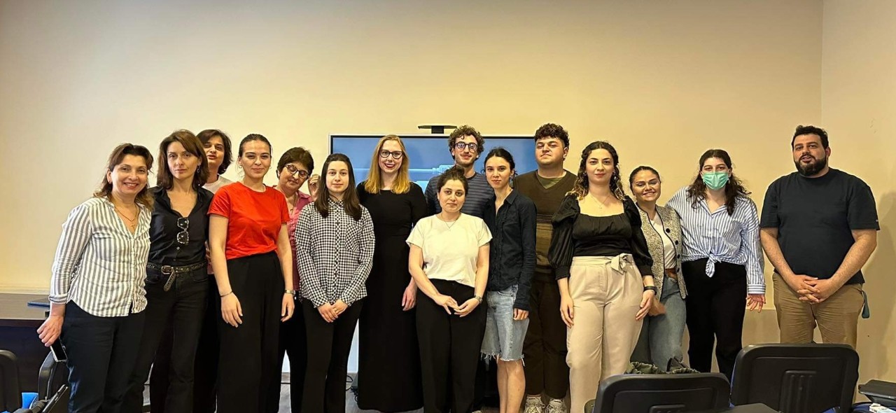 Michelle Burbage and faculty and staff of TMA stand and smile in a classroom