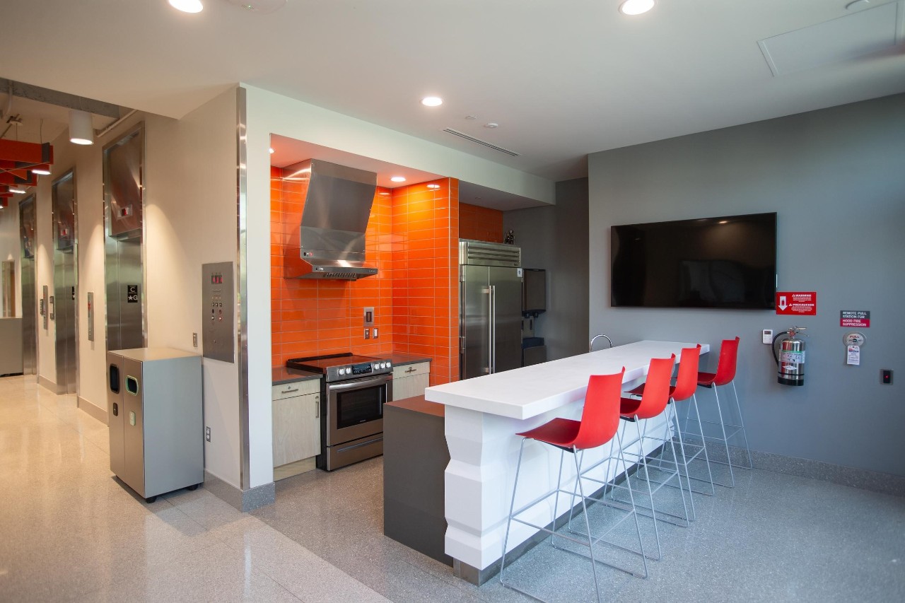 image of siddall hall kitchen area showing stove, cabinets, eating areas with tables and chairs