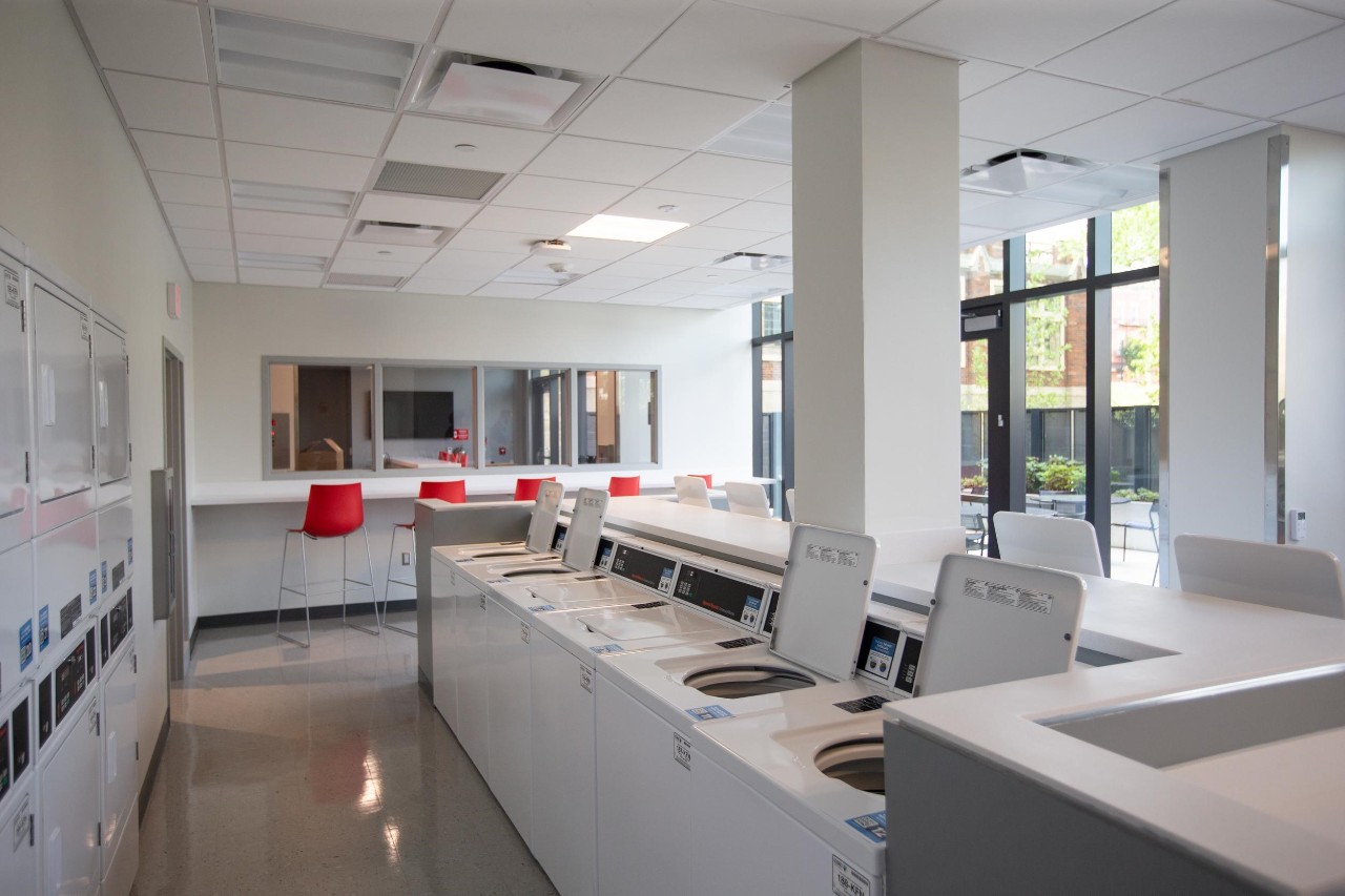 Image of several washing machines and dryers in Siddall Laundry room