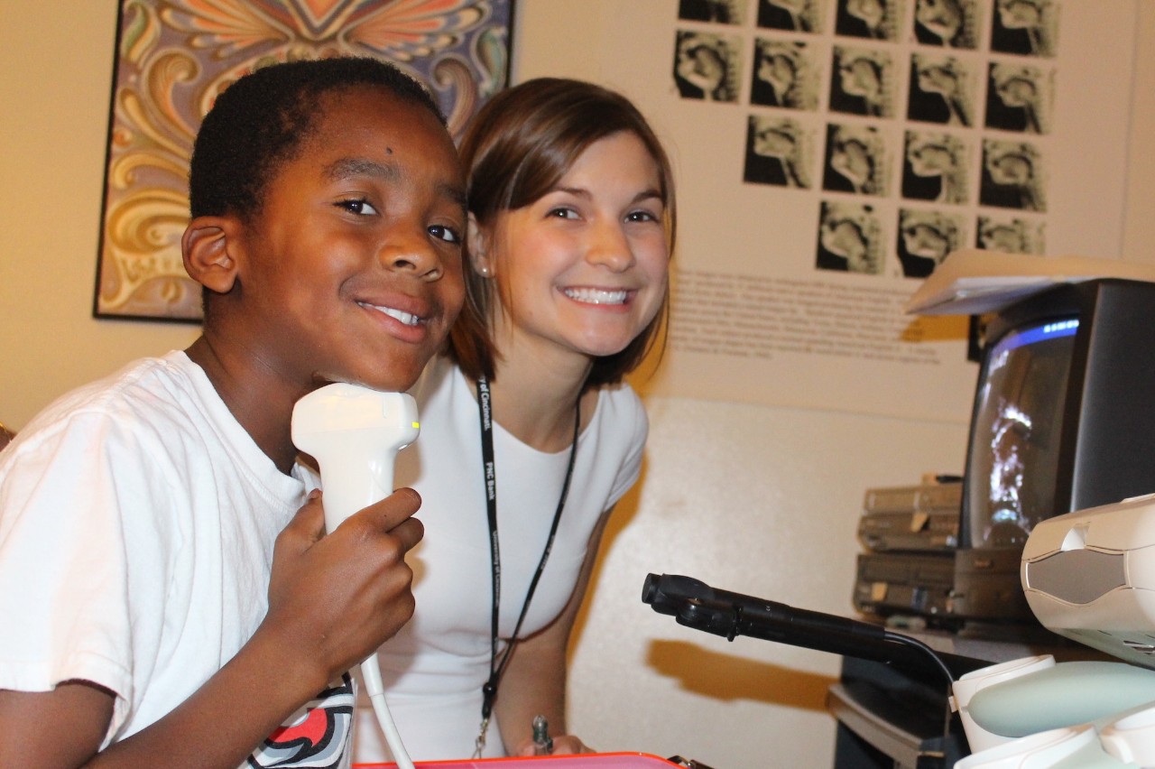 A student and a child at a health clinic