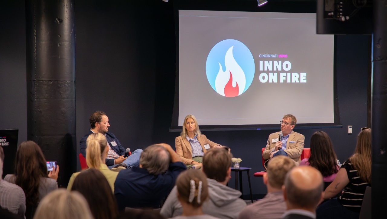 Ryan Hays speaks to attendees JB Kropp (far left) and Emma Off (center)