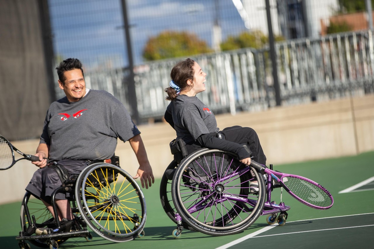 Jacob Counts, UC's Adaptive Athletics Coordinator, with UC adaptive sports athletes Seth Miller, Jaime Mazzi, and Logan Cover.