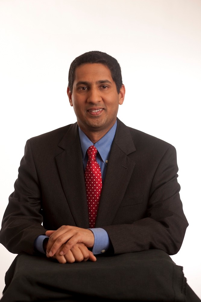 Arun Murthy wearing a suit and red tie.