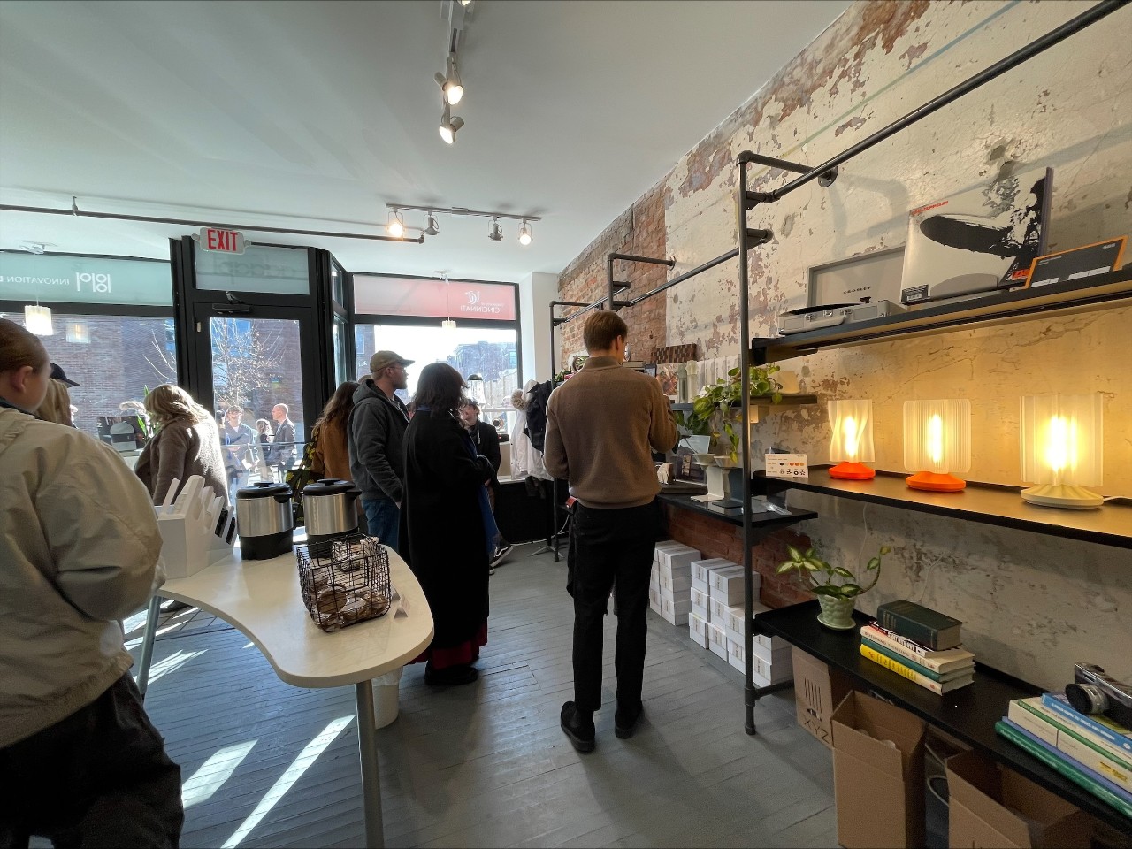 Students and shoppers browse inside ADAAPT storefront.