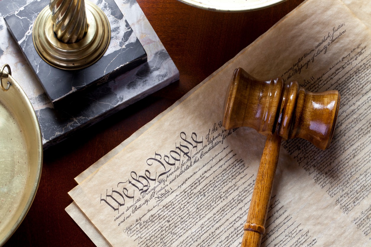 Photo of the US Constitution with a gavel overlaid