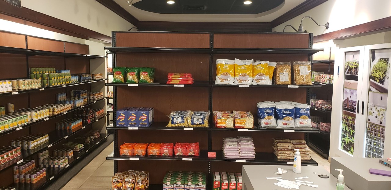 image inside the pantry shows several shelves stocked with food items