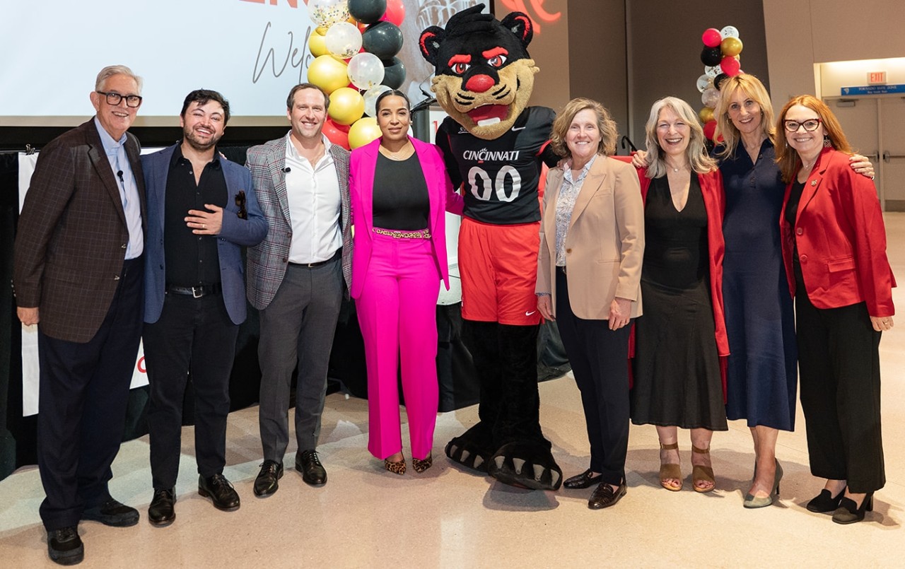 2025 Warren Bennis Leadership Experience speakers pose in professional dress in front of the stage.