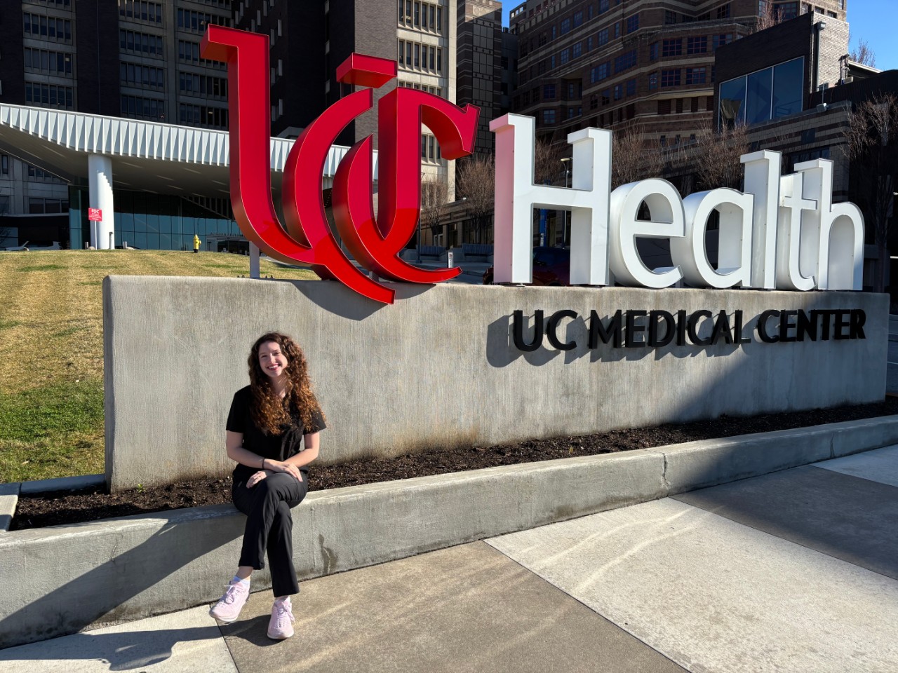 Student Kate Carey seated outside University of Cincinnati Medical Center.