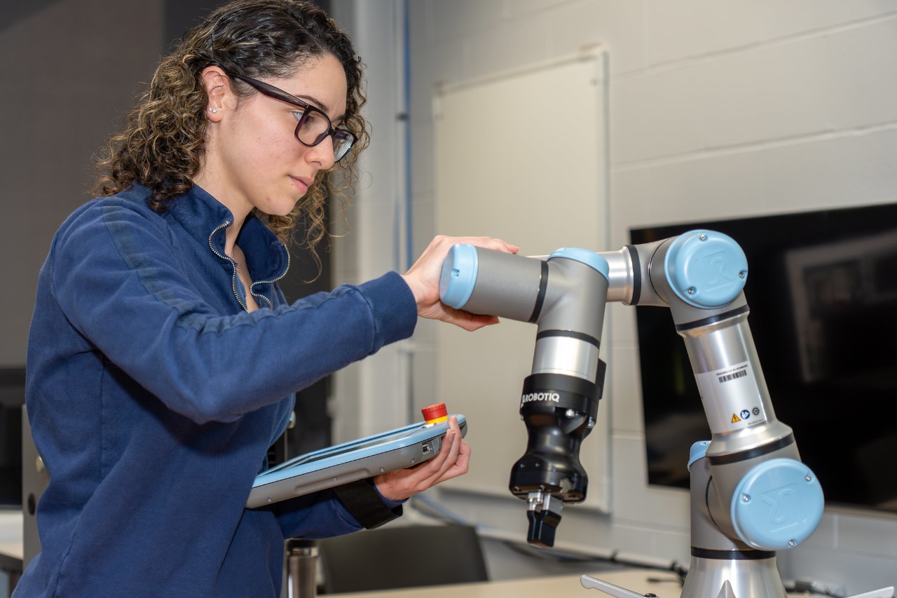 Dorca Torres Figueroa, who will graduate from UC Clermont with her associate degree in Manufacturing Engineering Technology in May, works in the college’s robotics lab. 