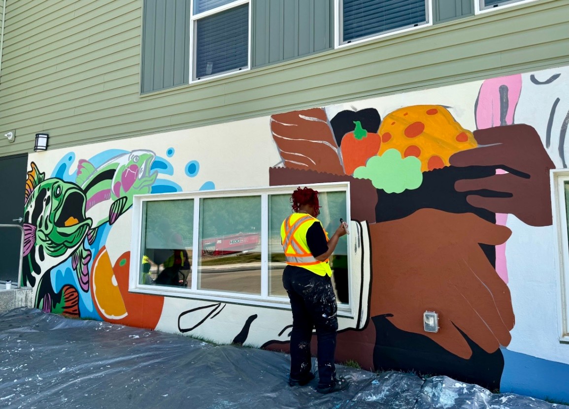 person painting a mural