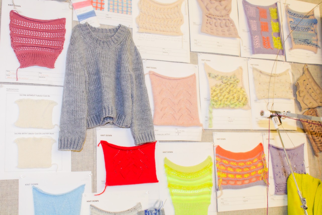 knitted sweater and yarn on a wall