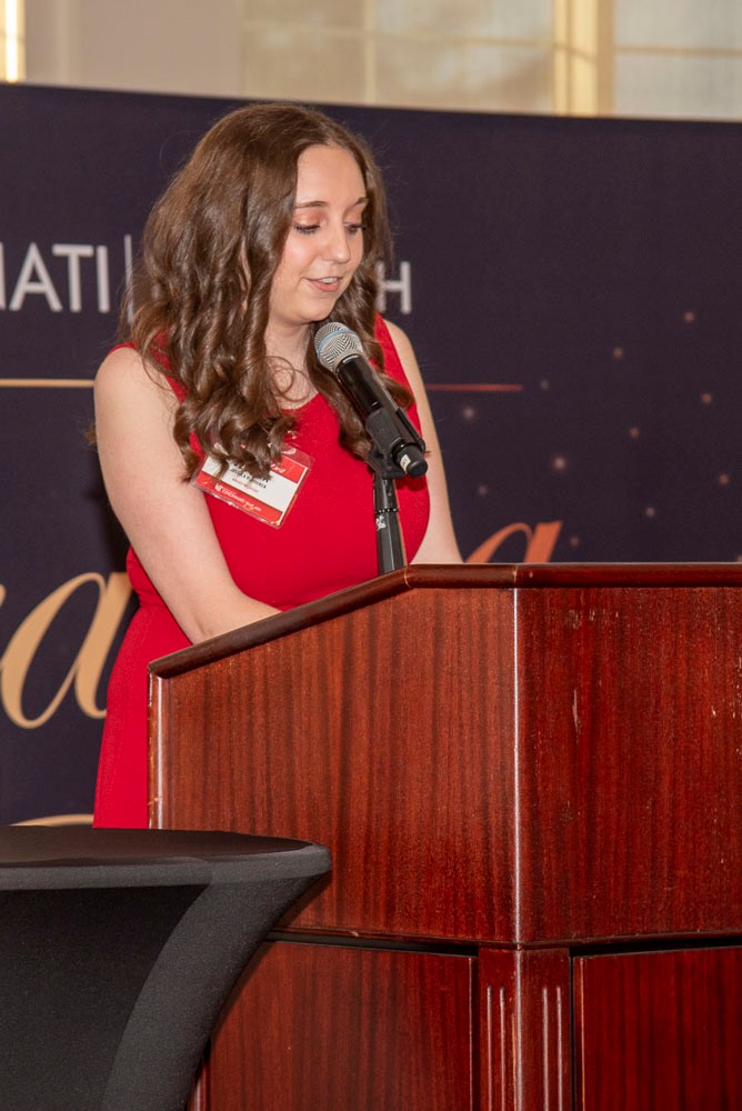 female student speaking at podium