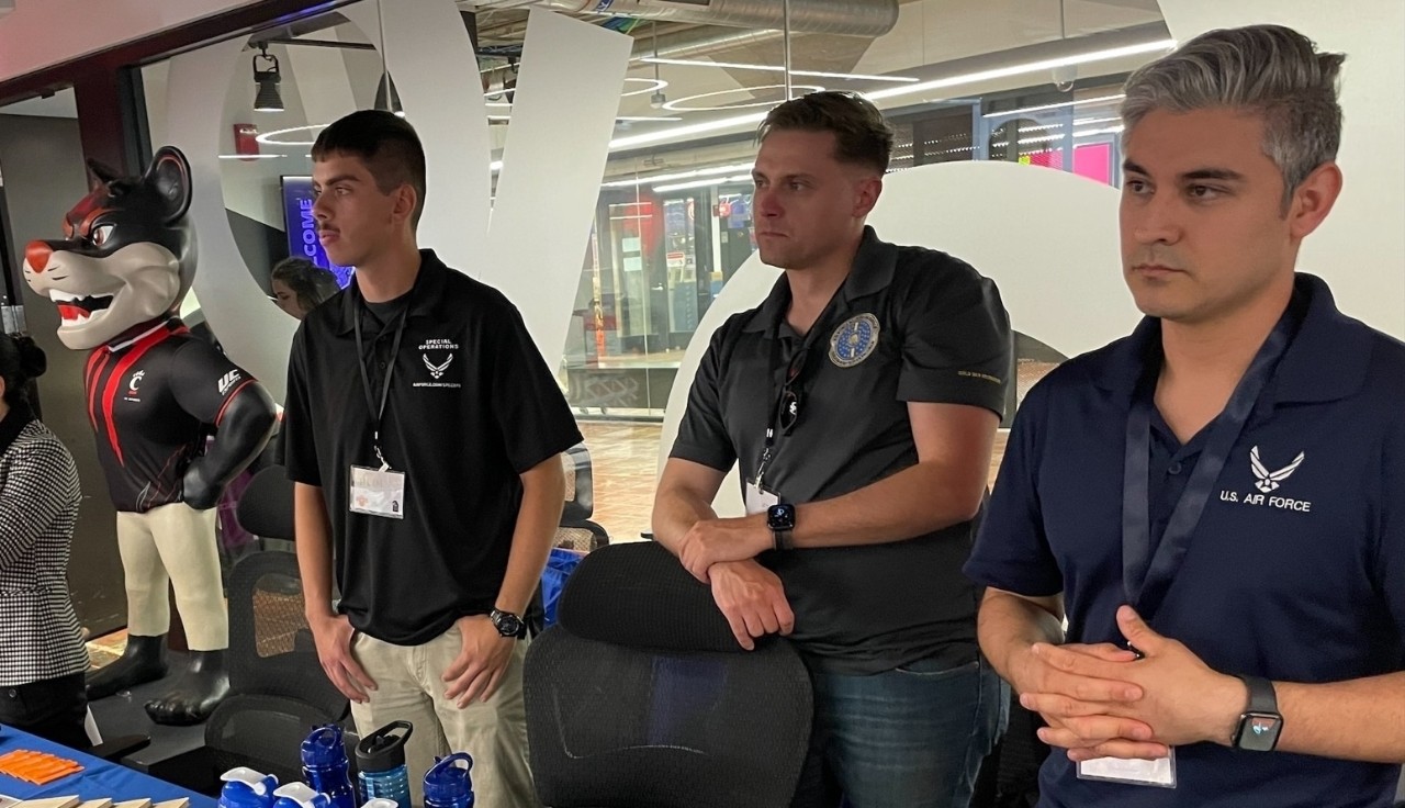 Career fair employers speak with attendees. 