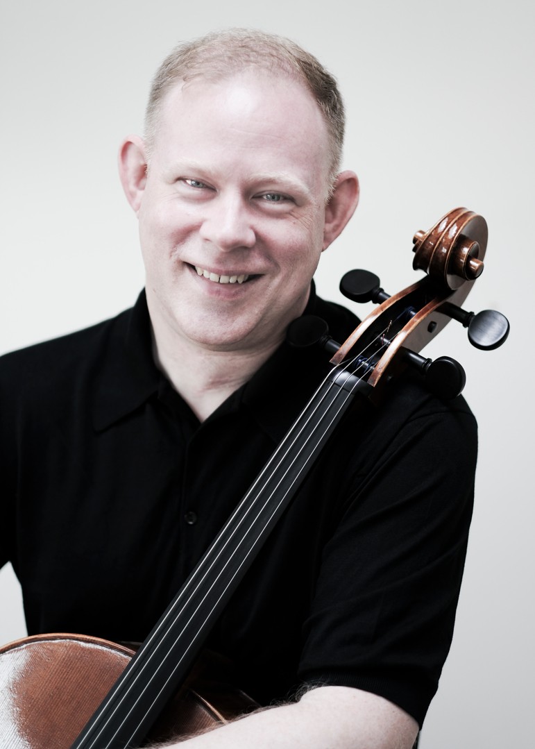 A portrait of incoming CCM faculty member Benjamin Hughes with his cello. Photo by Jack Liebeck.