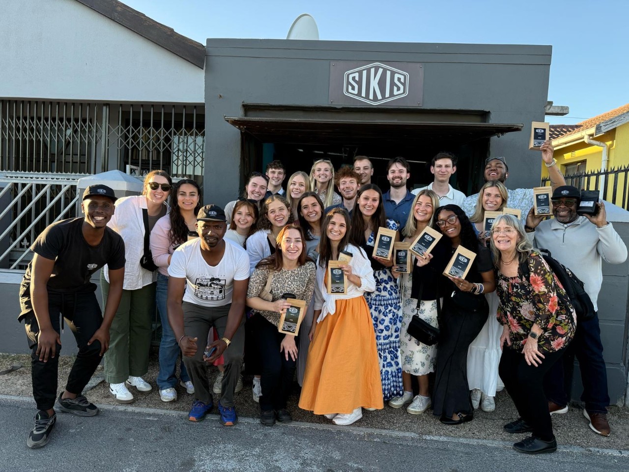 Lindner study abroad students, entrepreneurs and professor Manning smile for a group photo.