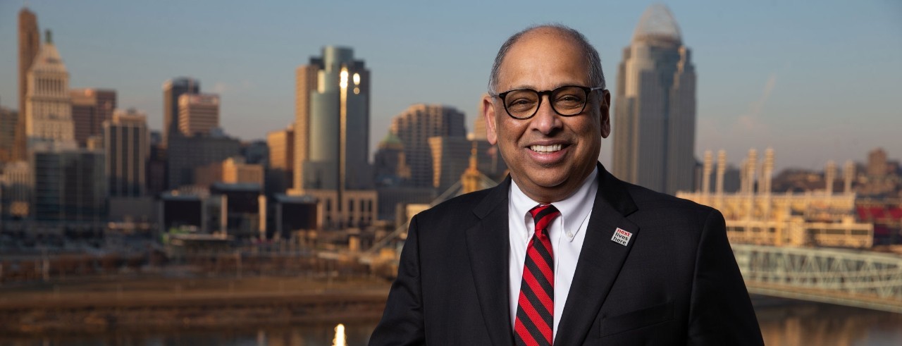 UC President Neville G. Pinto in front of the Cincinnati skyline