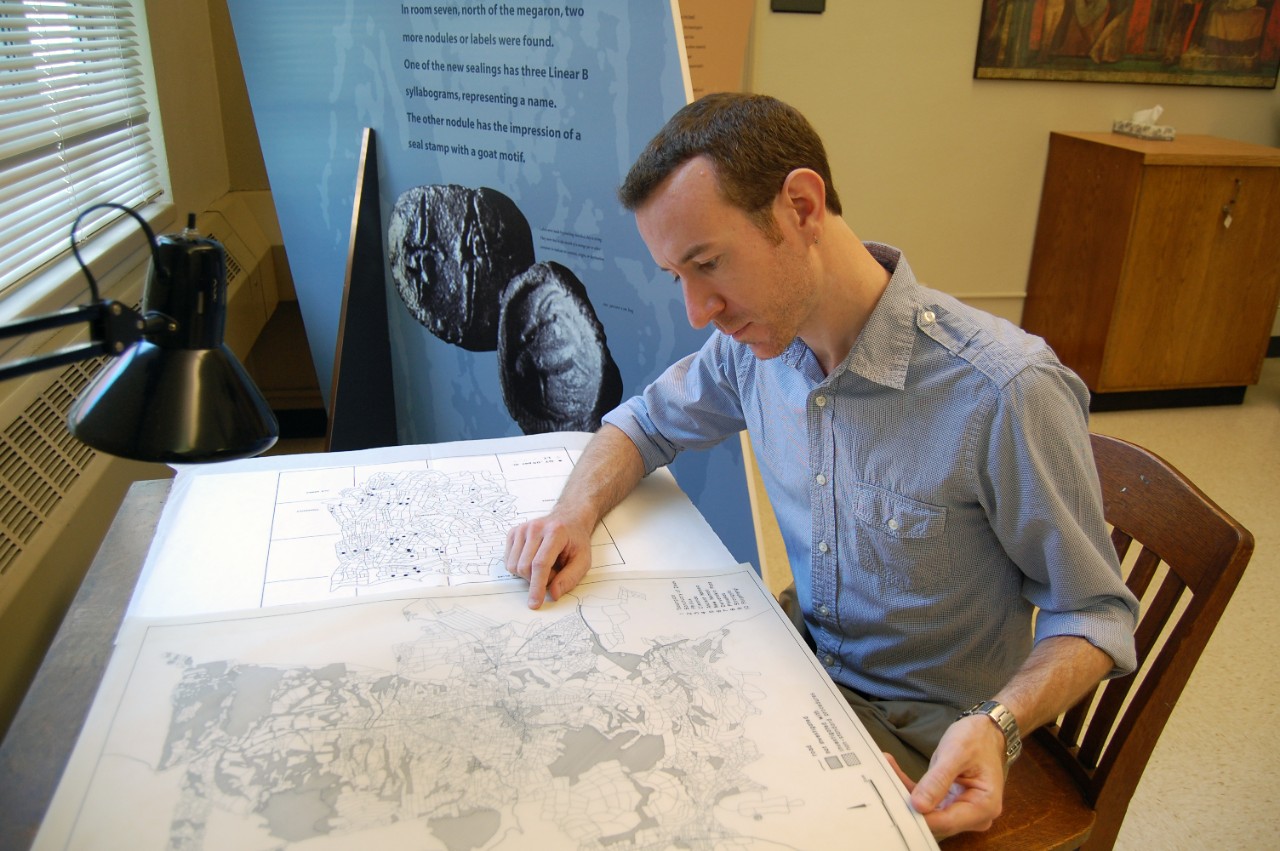 A UC grad student looks intensely at a map