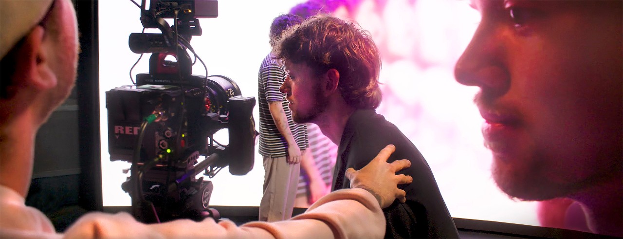 Students and faculty work in front of the 16x10 foot LED wall in CCM's virtual production studio in a still image from the "An Inside Look at CCM's XR Studio" video.
