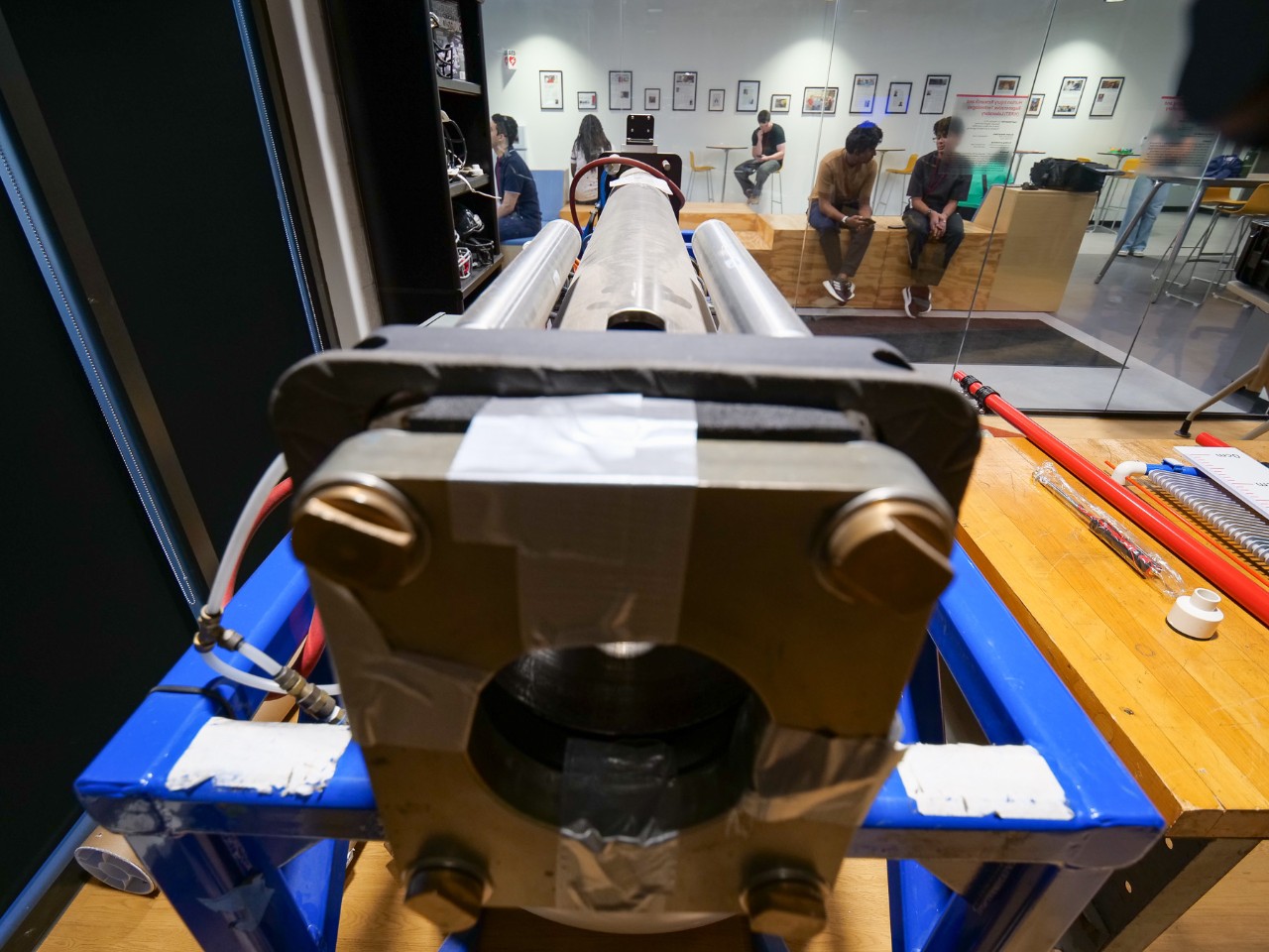 A hydraulic pitching machine sits in a biomedical engineering lab.