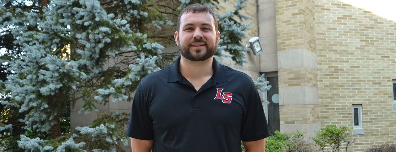 Zach Schmucker smiles as he stands in the courtyard of La Salle High School