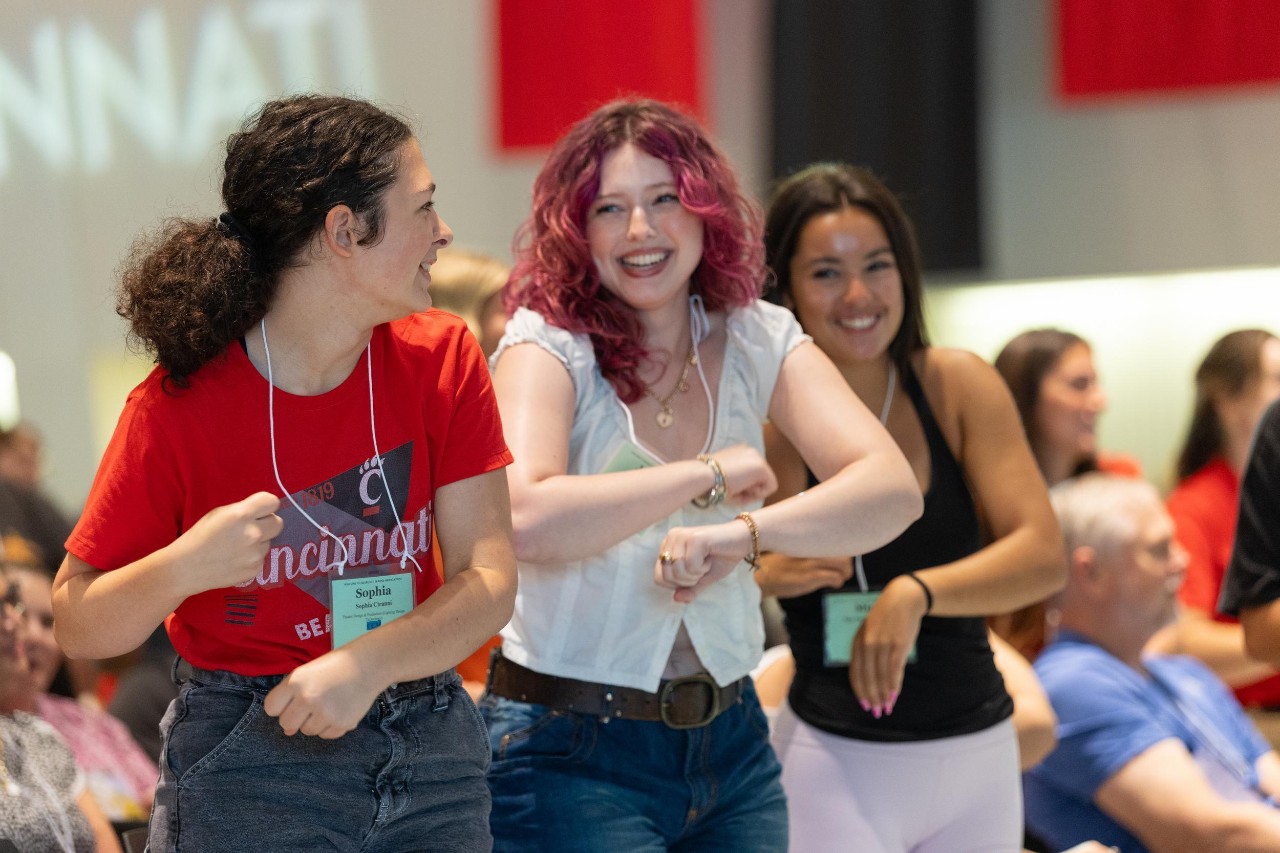 Two UC students laugh together at UC's freshman orientation