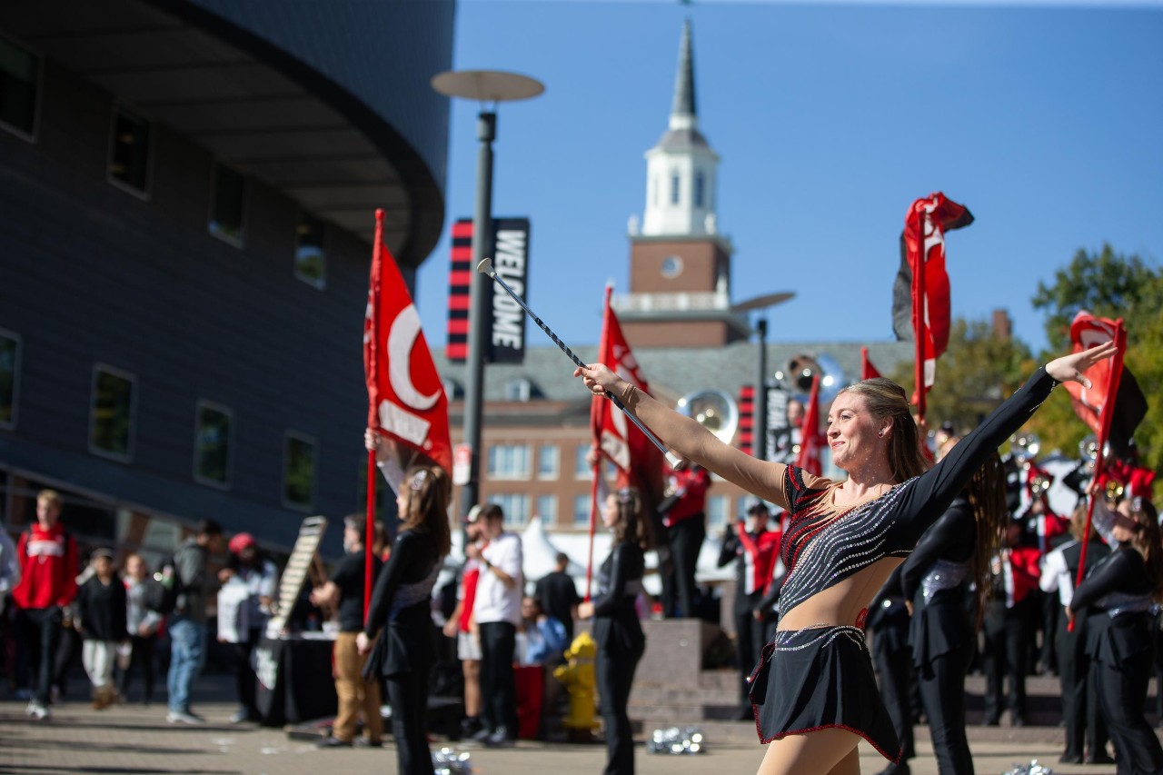 UC band and cheerleaders on campus during Homecoming