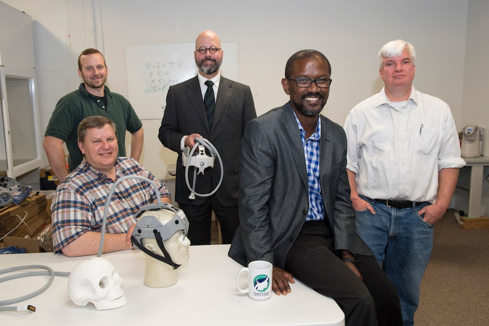 Drs. George Shaw, Matthew Flaherty and Ope Adeoye with Dan Kincaid and Joe Korfig.  Group photo with brain device.