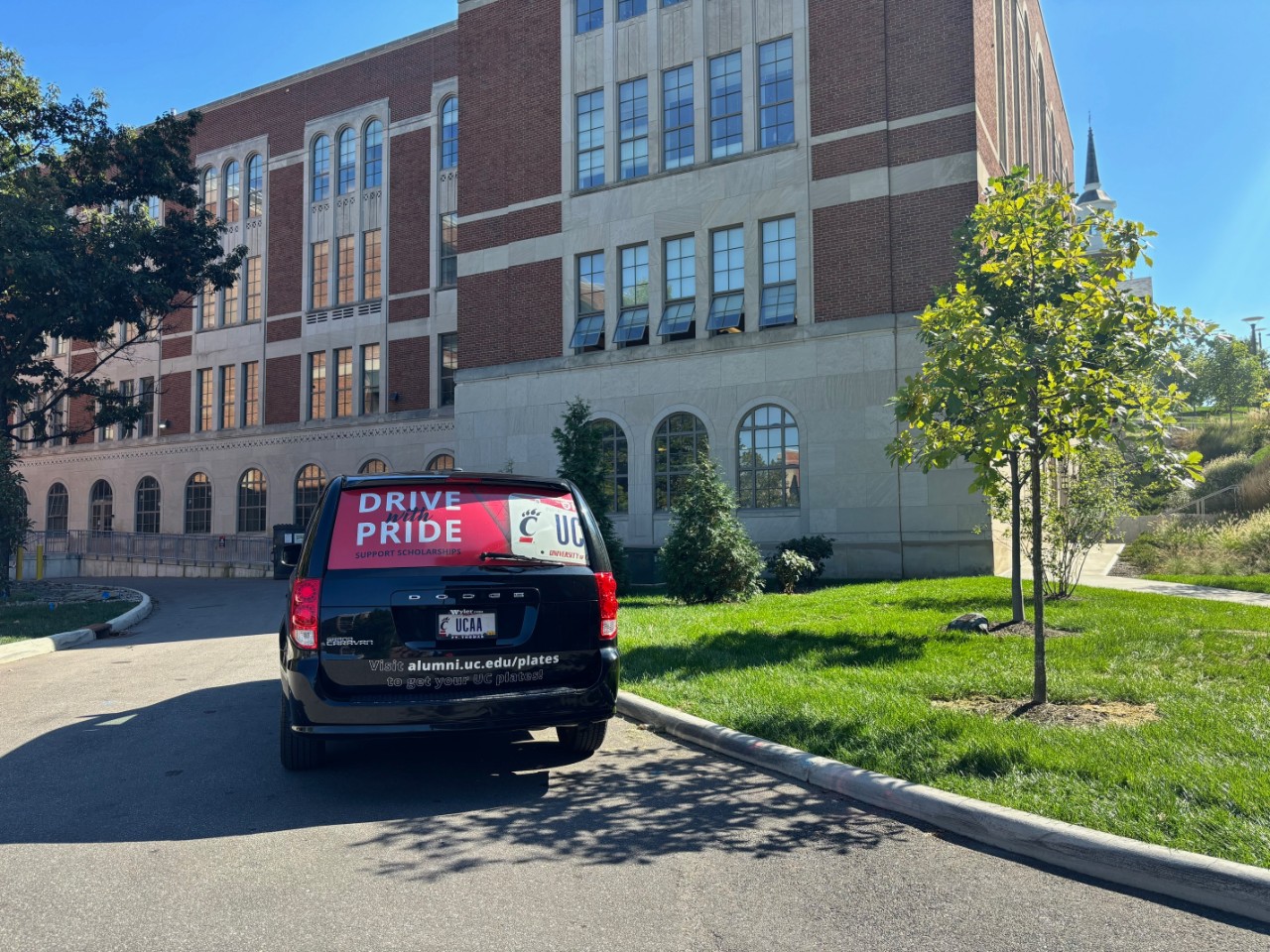 UC Alumni Association van which reads "Drive with Pride"