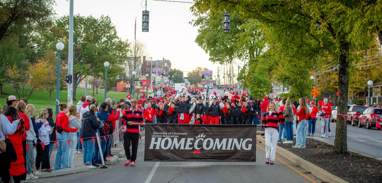 UC Alumni Association Homecoming banner at the start of the 2025 Homecoming Parade