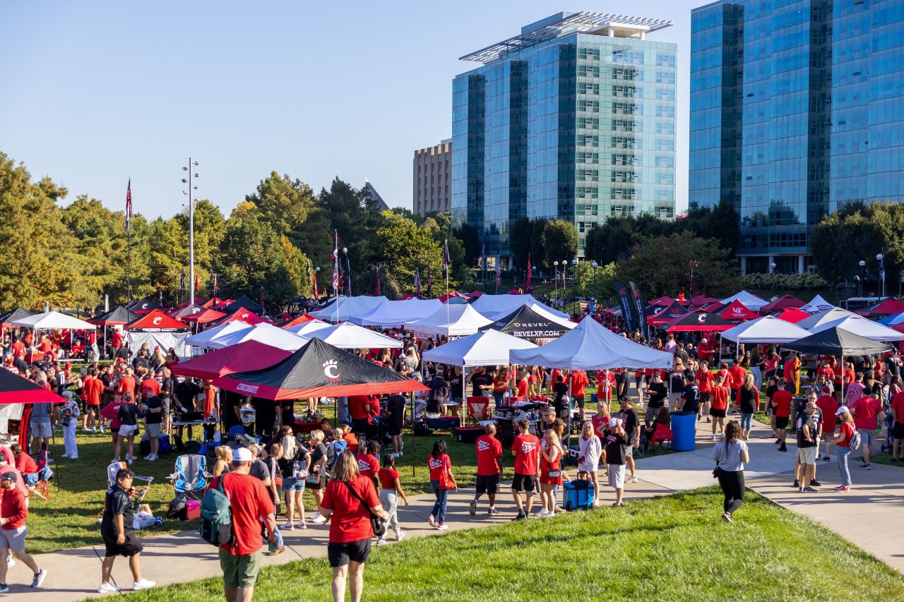 displays of scores of tents with hundreds of people tailgating on Sigma Sigma Commons