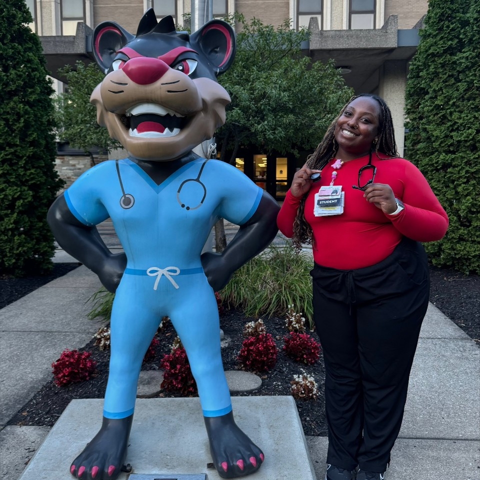 Bailey posing by the Bearcat statue